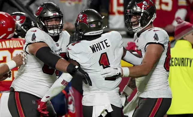 Tampa Bay Buccaneers running back Rachaad White (1) celebrates with teammates his touchdown against the Kansas City Chiefs during the first half of an NFL football game, Monday, Nov. 4, 2024, in Kansas City, Mo. (AP Photo/Charlie Riedel)