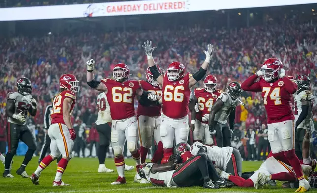 The Kansas City Chiefs celebrate a touchdown and win against the Tampa Bay Buccaneers during overtime of an NFL football game, Monday, Nov. 4, 2024, in Kansas City, Mo. (AP Photo/Ed Zurga)