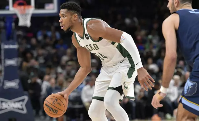 Milwaukee Bucks forward Giannis Antetokounmpo (34) handles the ball in the second half of an NBA basketball game against the Memphis Grizzlies Thursday, Oct. 31, 2024, in Memphis, Tenn. (AP Photo/Brandon Dill)