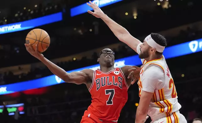 Chicago Bulls forward Jalen Smith (7) takes a shot against Atlanta Hawks forward Larry Nance Jr. (22) during the first half of an NBA basketball game Saturday, Nov. 9, 2024, in Atlanta. (AP Photo/ John Bazemore)