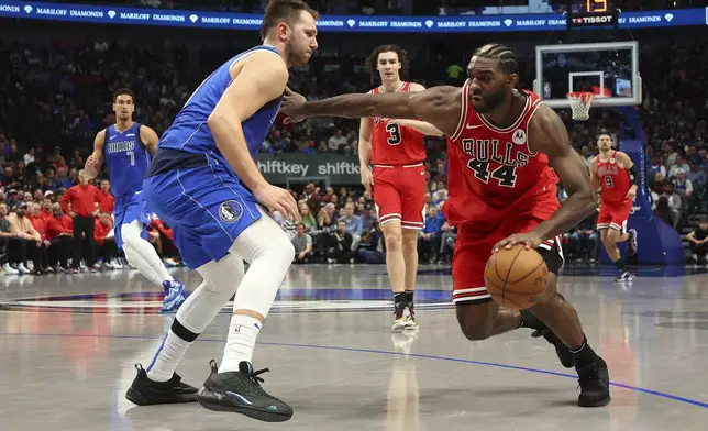 Dallas Mavericks guard Luka Doncic (77) defends as Chicago Bulls forward Patrick Williams (44) tries to get past him in the first half of an NBA basketball game Wednesday, Nov. 6, 2024, in Dallas. (AP Photo/Richard W. Rodriguez)