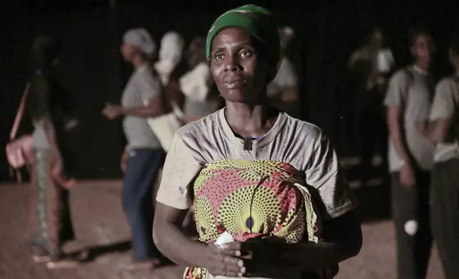 Fanta Charlotte Denbe, a mother of three who fled her village after it was attacked by extremists, participates in Recreatrales, an international theater festival held in Ouagadougou, Burkina Faso, Monday, Oct. 28, 2024. (AP Photo/Kilaye Bationo)