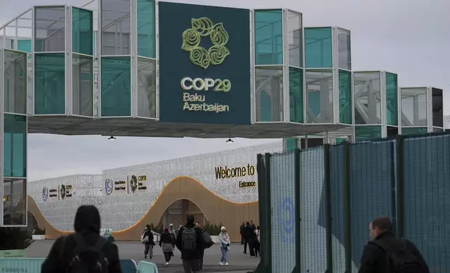 People arrive for the COP29 U.N. Climate Summit, Wednesday, Nov. 13, 2024, in Baku, Azerbaijan. (AP Photo/Peter Dejong)