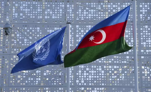 A flag for the United Nations and Azerbaijan are displayed outside the venue for the COP29 U.N. Climate Summit, Sunday, Nov. 10, 2024, in Baku, Azerbaijan. (AP Photo/Peter Dejong)