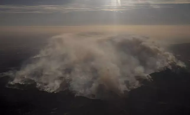 Smoke rises from the Mountain Fire as seen from a commercial flight near Ventura County, California, Wednesday Nov. 6, 2024. (Stephen Lam/San Francisco Chronicle via AP)