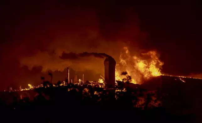 Flames engulf a structure during the Mountain Fire in Camarillo, Calif., Wednesday, Nov. 6, 2024. (Stephen Lam/San Francisco Chronicle via AP)