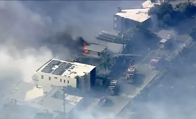 In this aerial still image provided by KABC-TV, shows Los Angeles County Fire Department crews scrambled to contain a small blaze fed by erratic wind gusts that pushed flames through dry brush near Broad Beach along Pacific Coast Highway in Malibu on Wednesday, Nov. 6, 2024. (KABC-TV via AP)