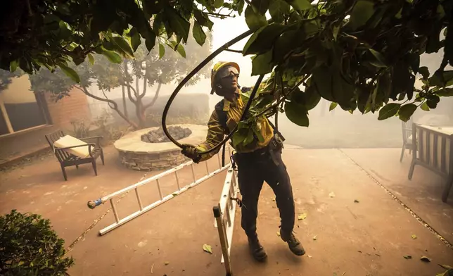 A firefighter works in the Mountain fire, Wednesday, Nov. 6, 2024, near Camarillo, Calif. (AP Photo/Ethan Swope)