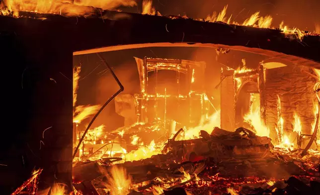 Flames consume a home as the Mountain Fire burns in Camarillo, Calif., on Wednesday, Nov. 6, 2024. (AP Photo/Noah Berger)