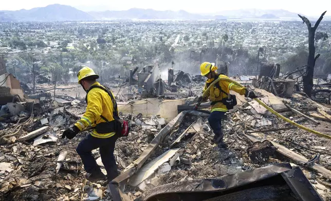 La Habra firefighters work hotspots from the Mountain Fire along West Highland Drive, Thursday, Nov. 7, 2024, in the hills of Camarillo, Calif. (Sarah Reingewirtz/The Orange County Register via AP)