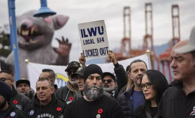 NDP Leader Jagmeet Singh, front center, and MP Jenny Kwan, front second right, attend a rally with locked out International Longshore and Warehouse Union Local 514 port workers and their supporters, in Vancouver, British Columbia, Friday, Nov. 8, 2024. (Darryl Dyck/The Canadian Press via AP)