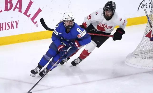 U.S. defenseman Haley Winn (8) skates up the ice past Canada forward Brianne Jenner (19) during the first period of a women's Rivalry Series hockey game in San Jose, Calif., Wednesday, Nov. 6, 2024. (AP Photo/Tony Avelar)