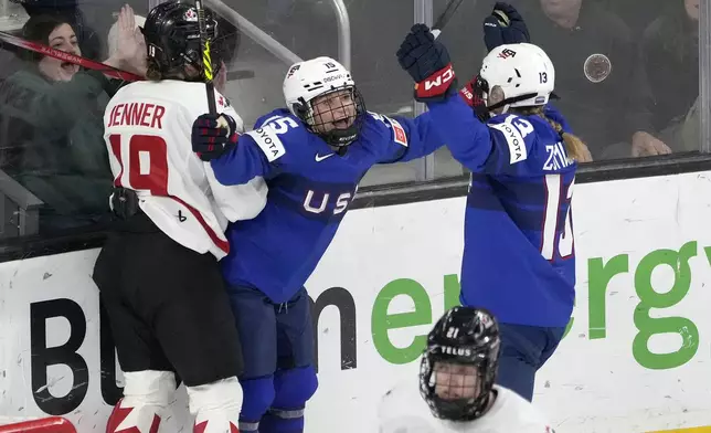 U.S. defense Savannah Harmon, center, celebrates with teammate Grace Zumwinkle (13) after scoring a goal against Canada during the first period of a women's Rivalry Series hockey game in San Jose, Calif., Wednesday, Nov. 6, 2024. (AP Photo/Tony Avelar)