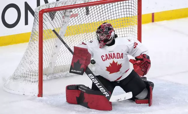 Canada goaltender Kristen Campbell (50) can not make a stop on a goal by U.S. defenseman Savannah Harmon during the first period of a women's Rivalry Series hockey game in San Jose, Calif., Wednesday, Nov. 6, 2024. (AP Photo/Tony Avelar)