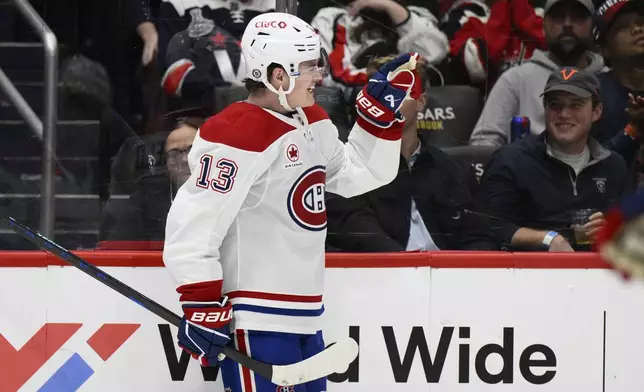 Montreal Canadiens right wing Cole Caufield (13) celebrates his goal during the second period of an NHL hockey game against the Washington Capitals, Thursday, Oct. 31, 2024, in Washington. (AP Photo/Nick Wass)