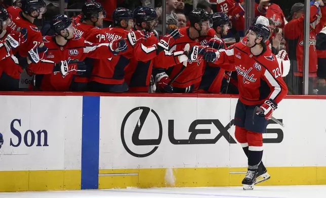 Washington Capitals right wing Brandon Duhaime (22) celebrates at the bench after scoring a goal during the second period of an NHL hockey game against the Montreal Canadiens, Thursday, Oct. 31, 2024, in Washington. (AP Photo/Nick Wass)