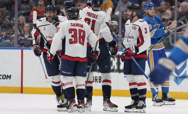 Washington Capitals' Alex Ovechkin, left, is congratulated by teammates after scoring during the second period of an NHL hockey game against the St. Louis Blues Saturday, Nov. 9, 2024, in St. Louis. (AP Photo/Jeff Roberson)