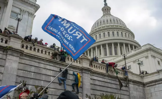 FILE - Support of President Donald Trump climb the West wall of the the U.S. Capitol, Jan. 6, 2021, in Washington. (AP Photo/Jose Luis Magana, File)