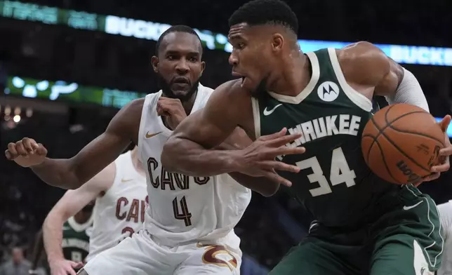 Milwaukee Bucks' Giannis Antetokounmpo tries to get past Cleveland Cavaliers' Evan Mobley during the first half of an NBA basketball game Saturday, Nov. 2, 2024, in Milwaukee. (AP Photo/Morry Gash)