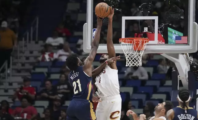 Cleveland Cavaliers forward Evan Mobley blocks a shot by New Orleans Pelicans center Yves Missi (21) in the first half of an NBA basketball game in New Orleans, Wednesday, Nov. 6, 2024. (AP Photo/Gerald Herbert)