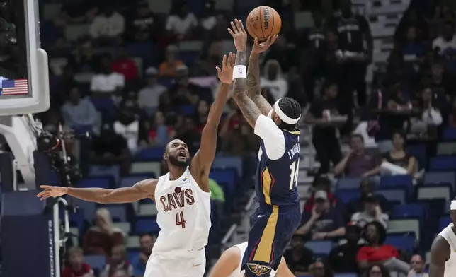 New Orleans Pelicans forward Brandon Ingram (14) shoots against Cleveland Cavaliers forward Evan Mobley (4) in the first half of an NBA basketball game in New Orleans, Wednesday, Nov. 6, 2024. (AP Photo/Gerald Herbert)