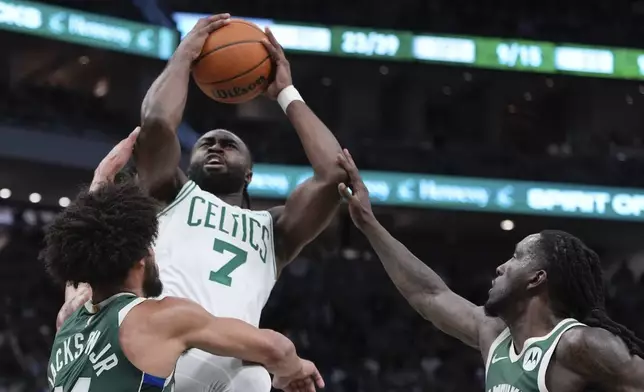 Boston Celtics' Jaylen Brown is fouled shooting between Milwaukee Bucks' Chris Livingston and Andre Jackson Jr. during the first half of an NBA basketball game Sunday, Nov. 10, 2024, in Milwaukee. (AP Photo/Morry Gash)