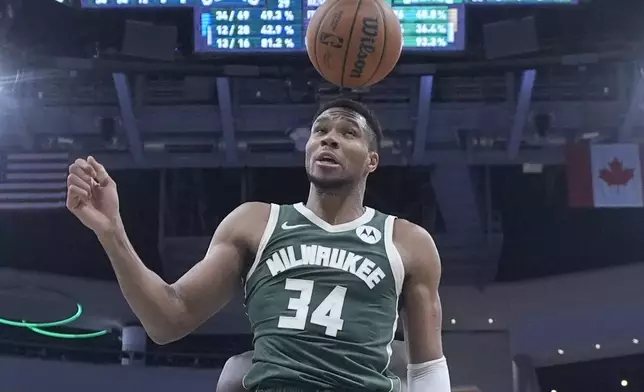 Milwaukee Bucks' Giannis Antetokounmpo hits the ball with his head after a shot during the second half of an NBA basketball game against the Boston Celtics Sunday, Nov. 10, 2024, in Milwaukee. (AP Photo/Morry Gash)