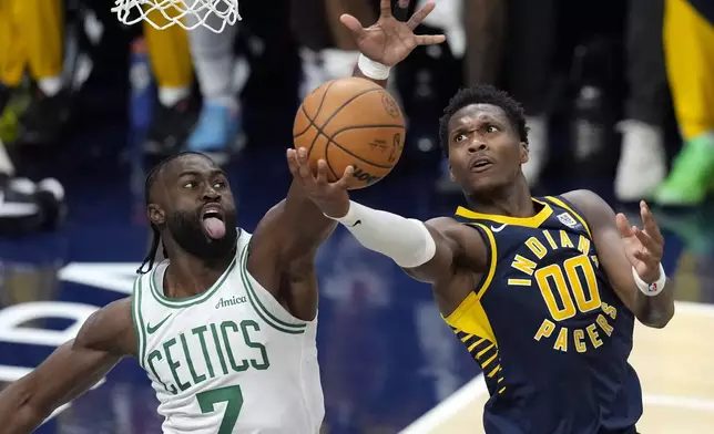 Indiana Pacers' Bennedict Mathurin (00) puts up a shot as Boston Celtics' Jaylen Brown (7) defends during the first half of an NBA basketball game, Wednesday, Oct. 30, 2024, in Indianapolis. (AP Photo/Darron Cummings)