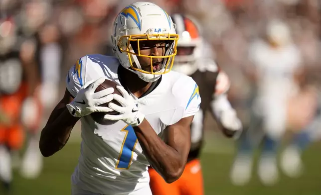 Los Angeles Chargers wide receiver Quentin Johnston (1) scores a touchdown on a 66-yard reception against the Cleveland Browns in the first half of an NFL football game Sunday, Nov. 3, 2024, in Cleveland. (AP Photo/Sue Ogrocki)