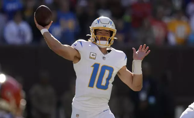 Los Angeles Chargers quarterback Justin Herbert passes against the Cleveland Browns in the first half of an NFL football game Sunday, Nov. 3, 2024, in Cleveland. (AP Photo/Sue Ogrocki)