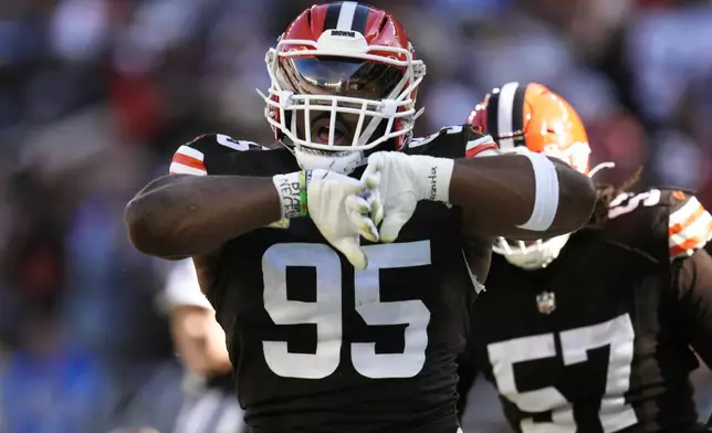 Cleveland Browns defensive end Myles Garrett (95) celebrates after sacking Los Angeles Chargers quarterback Justin Herbert in the first half of an NFL football game Sunday, Nov. 3, 2024, in Cleveland. (AP Photo/Sue Ogrocki)