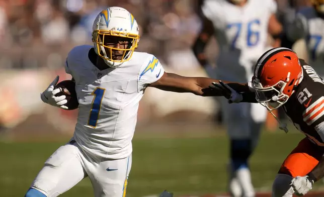Los Angeles Chargers wide receiver Quentin Johnston (1) runs against Cleveland Browns cornerback Denzel Ward (21) in the first half of an NFL football game Sunday, Nov. 3, 2024, in Cleveland. (AP Photo/Sue Ogrocki)