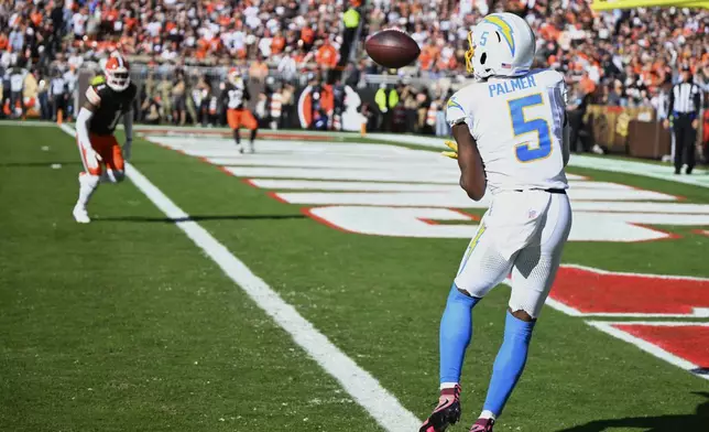 Los Angeles Chargers wide receiver Joshua Palmer (5) catches a touchdown pass against the Cleveland Browns in the first half of an NFL football game Sunday, Nov. 3, 2024, in Cleveland. (AP Photo/David Richard)
