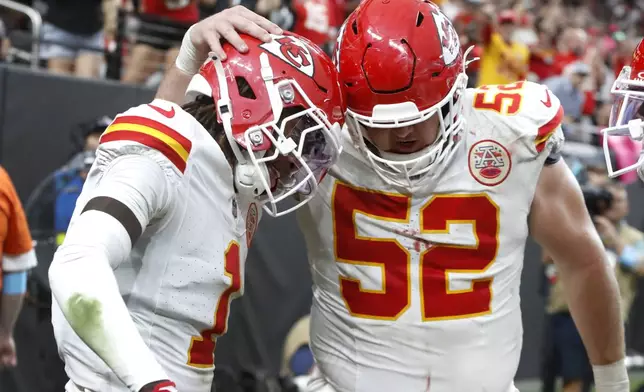 Kansas City Chiefs wide receiver Xavier Worthy (1) celebrates with center Creed Humphrey (52) after scoring a touchdown against the Las Vegas Raiders during the second half of an NFL football game Sunday, Oct. 27, 2024, in Las Vegas. (Steve Marcus/Las Vegas Sun via AP)