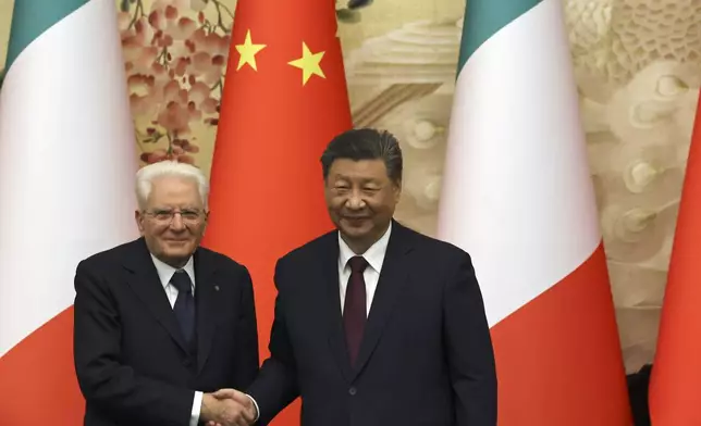 Chinese President Xi Jinping, right, and Italian President Sergio Mattarella shake hands at a signing ceremony at the Great Hall of the People in Beijing, Friday, Nov. 8, 2024. (Florence Lo/Pool Photo via AP)