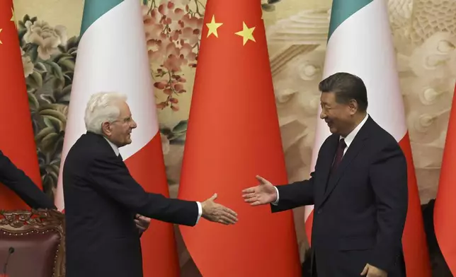 Chinese President Xi Jinping, right, and Italian President Sergio Mattarella shake hands at a signing ceremony at the Great Hall of the People in Beijing, Friday, Nov. 8, 2024. (Florence Lo/Pool Photo via AP)