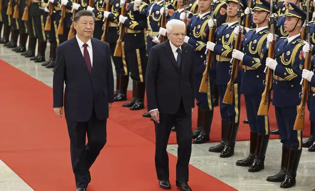 Chinese President Xi Jinping, left, and Italian President Sergio Mattarella review the honor guard during a welcome ceremony at the Great Hall of the People in Beijing Friday, Nov. 8, 2024. (Florence Lo/Pool Photo via AP)