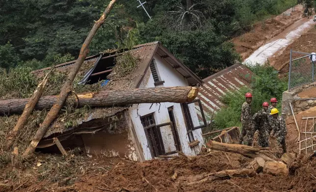 FILE - Rescuers search for the body of a missing doctor at the site of a landslide in Anandaban hospital, in the aftermath of a flood caused by heavy rains, in Lalitpur, Nepal, Oct. 1, 2024. (AP Photo/Niranjan Shrestha, File)