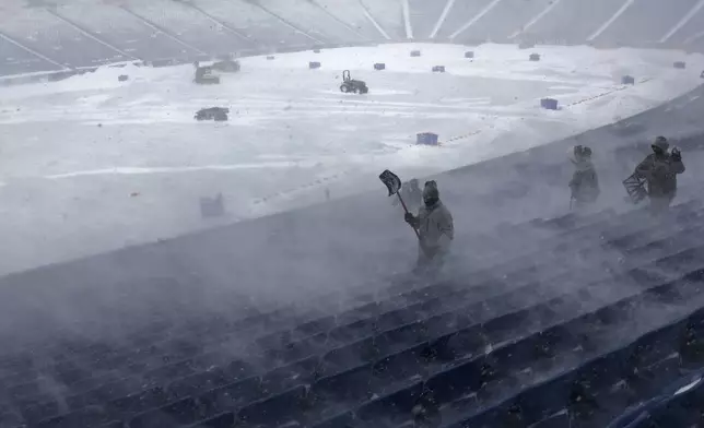 FILE - Workers remove snow from Highmark Stadium in Orchard Park, N.Y., Jan. 14, 2024. (AP Photo/Jeffrey T. Barnes, File)