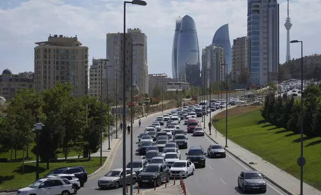 Vehicles travel down a street in Baku, Azerbaijan, Monday, Sept. 16, 2024. (AP Photo/Sergei Grits)