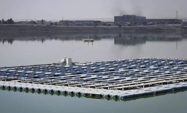 Solar panels float outside the Olympic Stadium, in Baku, Azerbaijan, Monday, Sept. 16, 2024. (AP Photo/Sergei Grits)