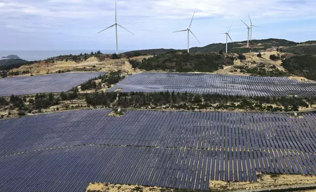 FILE - A solar farm operates near wind turbines in Quy Non, Vietnam on June 11, 2023. (AP Photo/Minh Hoang, File)