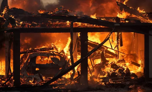 A home burns in the Mountain Fire, Nov. 6, 2024, in Camarillo, Calif. (AP Photo/Marcio Jose Sanchez)