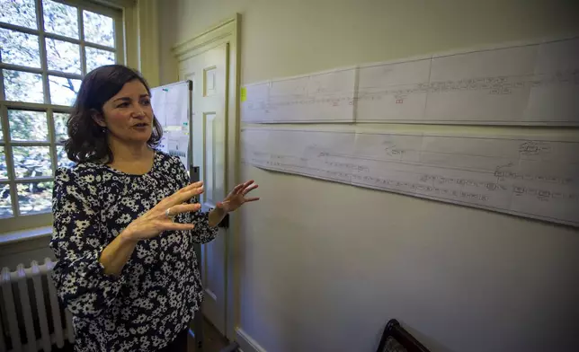 Elizabeth Drembus discusses the known family trees of some of the students that attended the Williamsburg Bray School on Wednesday, Oct 30, 2024 in Williamsburg, Va. (AP Photo/John C. Clark)