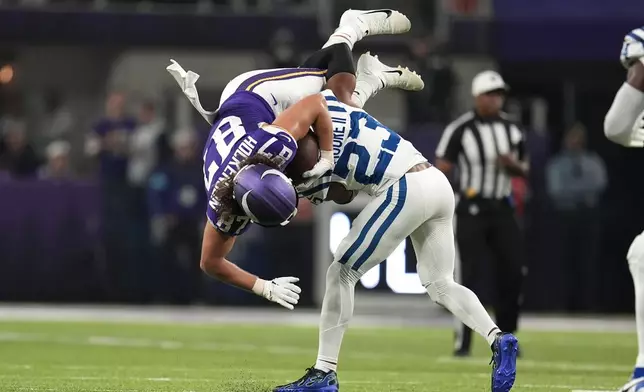 Minnesota Vikings tight end T.J. Hockenson (87) is tackled by Indianapolis Colts cornerback Kenny Moore II (23) after catching a pass during the first half of an NFL football game, Sunday, Nov. 3, 2024, in Minneapolis. (AP Photo/Abbie Parr)