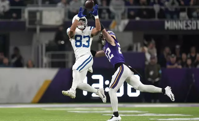 Indianapolis Colts tight end Kylen Granson (83) catches a pass over Minnesota Vikings safety Harrison Smith (22) during the first half of an NFL football game, Sunday, Nov. 3, 2024, in Minneapolis. (AP Photo/Abbie Parr)