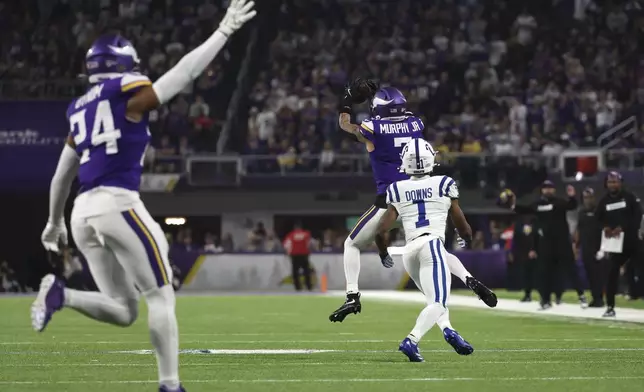 Minnesota Vikings cornerback Byron Murphy Jr. (7) intercepts a pass intended for Indianapolis Colts wide receiver Josh Downs (1) during the second half of an NFL football game, Sunday, Nov. 3, 2024, in Minneapolis. (AP Photo/Ellen Schmidt)