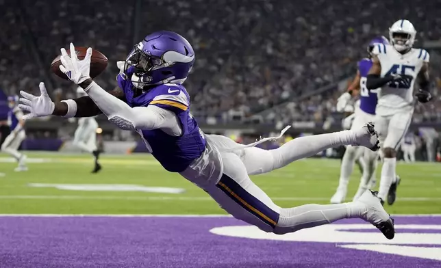 Minnesota Vikings wide receiver Jordan Addison (3) catches a 4-yard touchdown pass during the second half of an NFL football game against the Indianapolis Colts, Sunday, Nov. 3, 2024, in Minneapolis. (AP Photo/Abbie Parr)