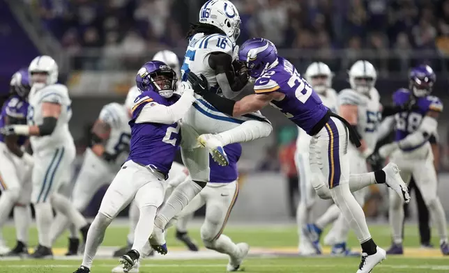 Minnesota Vikings cornerback Stephon Gilmore (2) and safety Harrison Smith (22) break up a pass intended for Indianapolis Colts wide receiver Ashton Dulin (16) during the second half of an NFL football game, Sunday, Nov. 3, 2024, in Minneapolis. (AP Photo/Abbie Parr)