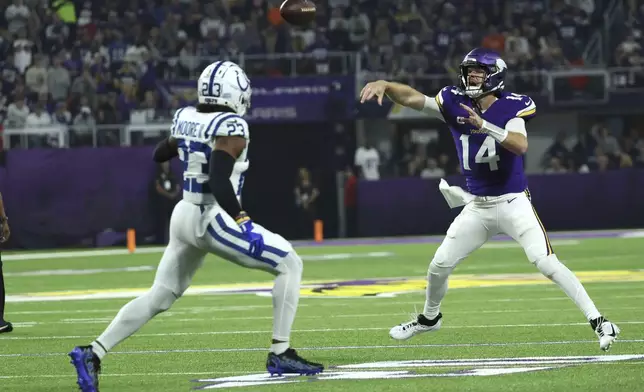 Minnesota Vikings quarterback Sam Darnold (14) throws a pass over Indianapolis Colts cornerback Samuel Womack III (33) during the first half of an NFL football game, Sunday, Nov. 3, 2024, in Minneapolis. (AP Photo/Ellen Schmidt)